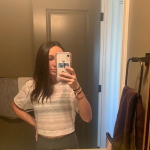 Open-hole, mesh fabric, white lululemon tee shirt.